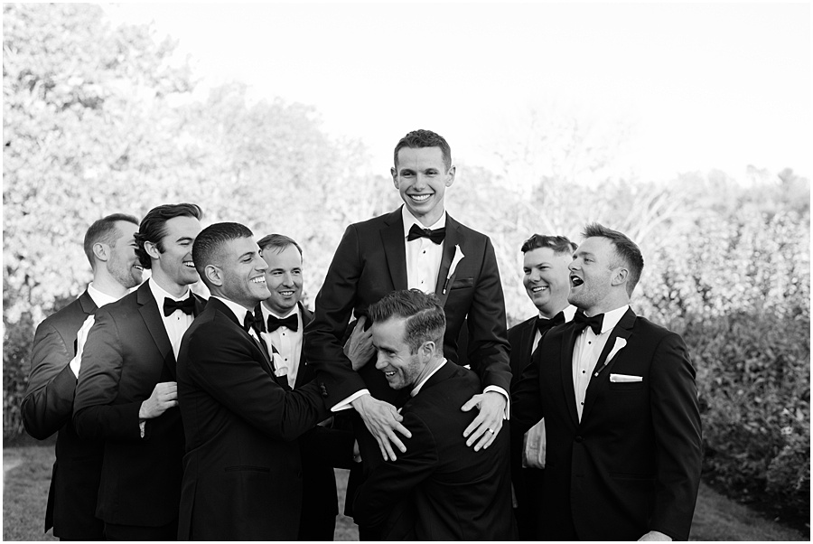 Groomsmen carrying groom- fun photo of guys