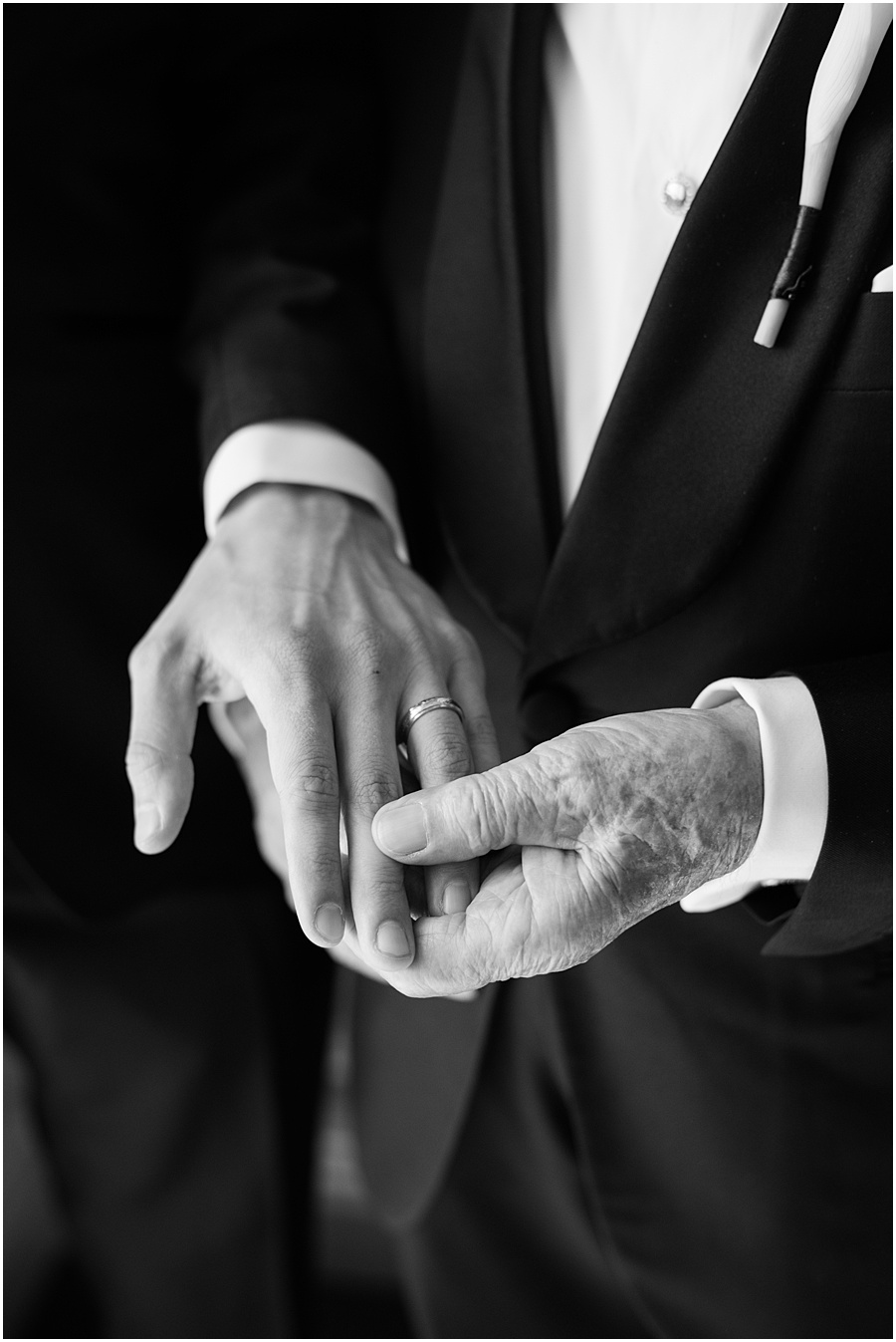 Grandfather holding Grandsons hand showing family heirloom ring